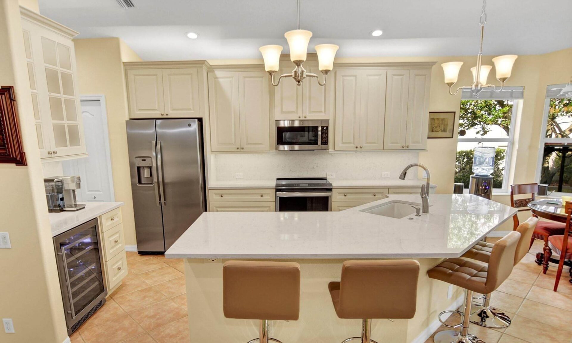 White quartzite counter with ivory cabinets — D and W SRQ, Sarasota